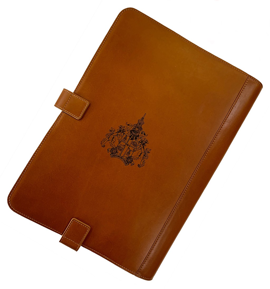 Brown leather presentation folder with detailed embossed crest by Furnells